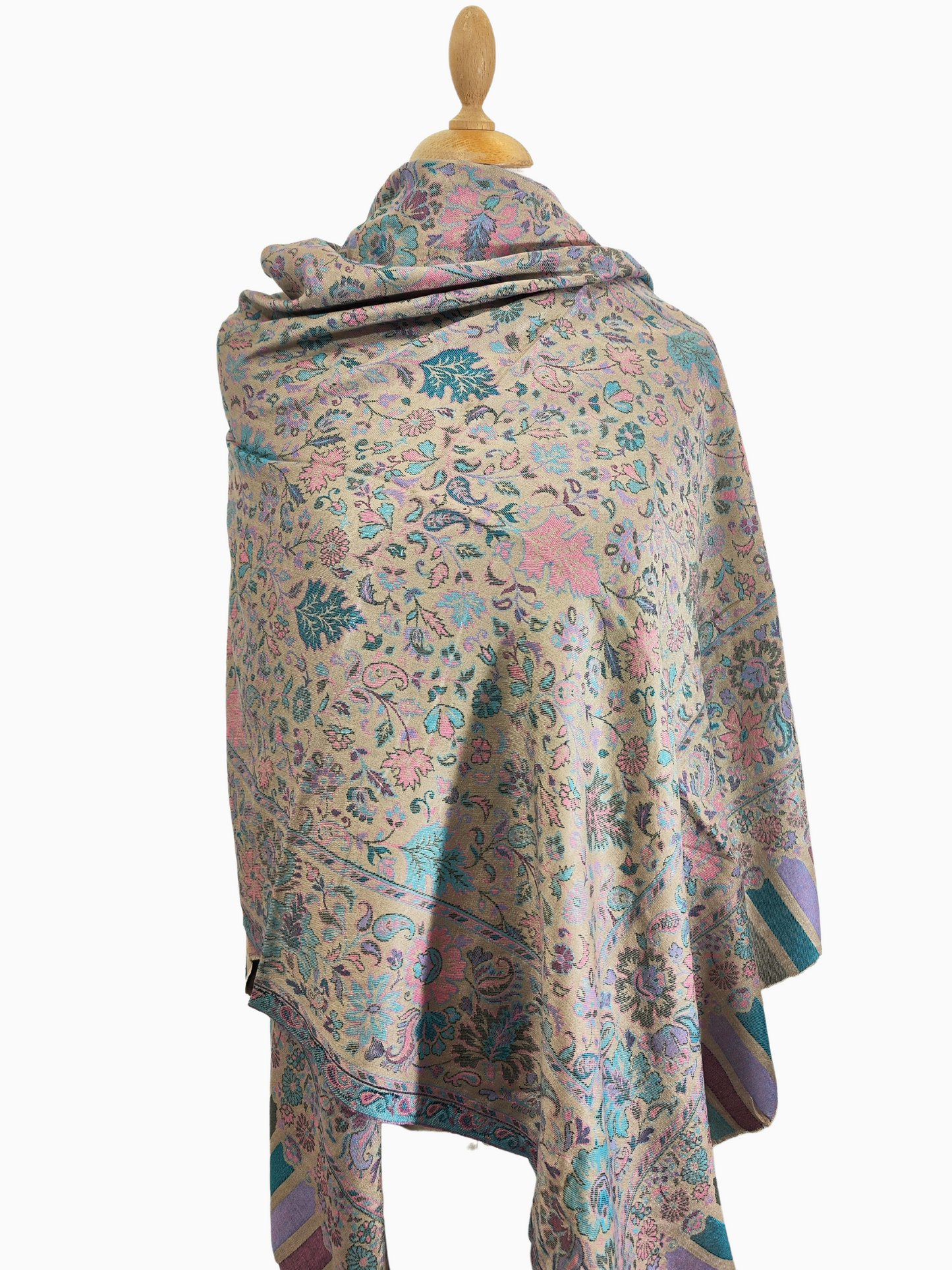 Soft, beige scarf with a delicate floral and paisley pattern in shades of pink, blue, and green