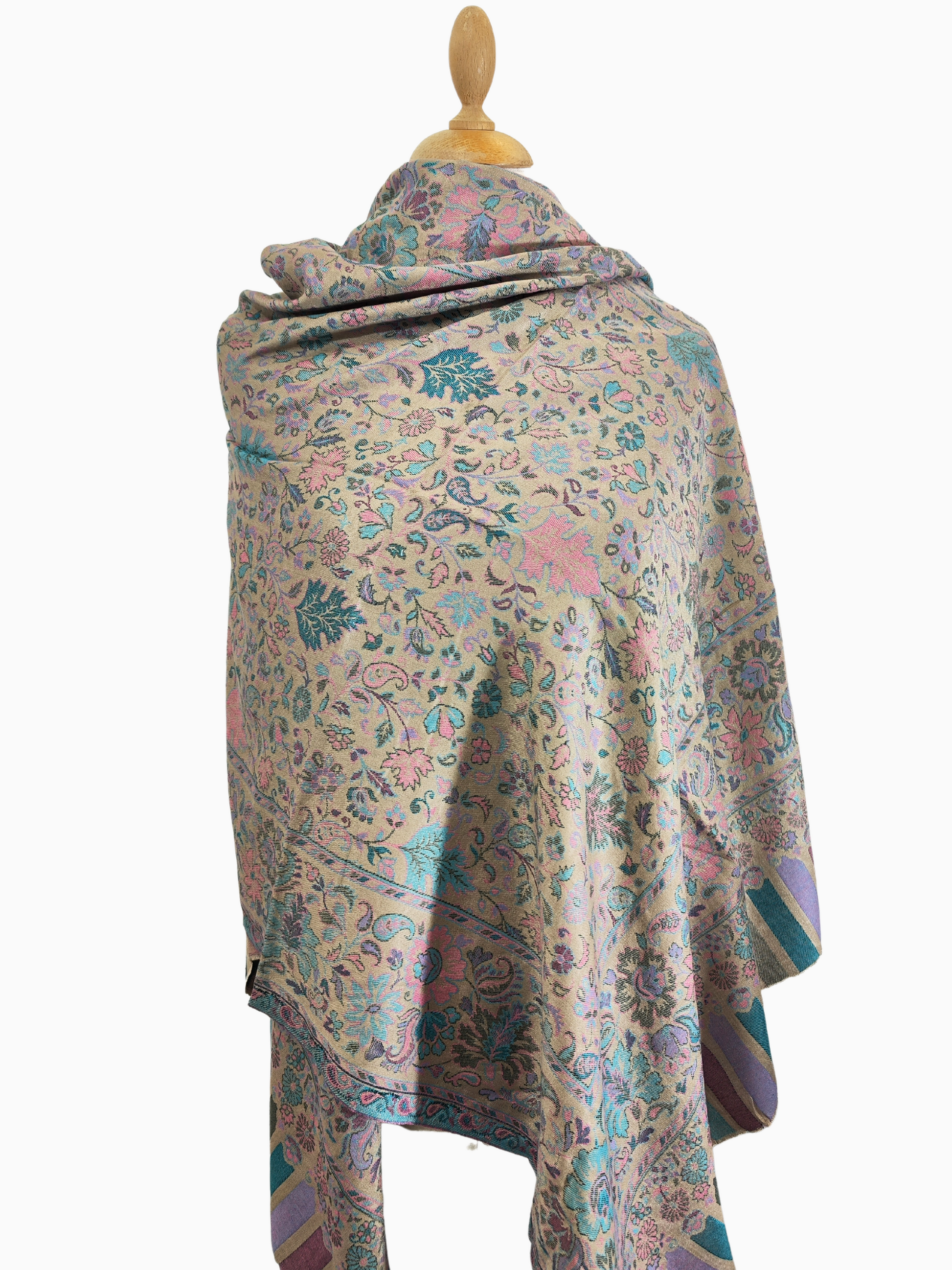 Soft, beige scarf with a delicate floral and paisley pattern in shades of pink, blue, and green