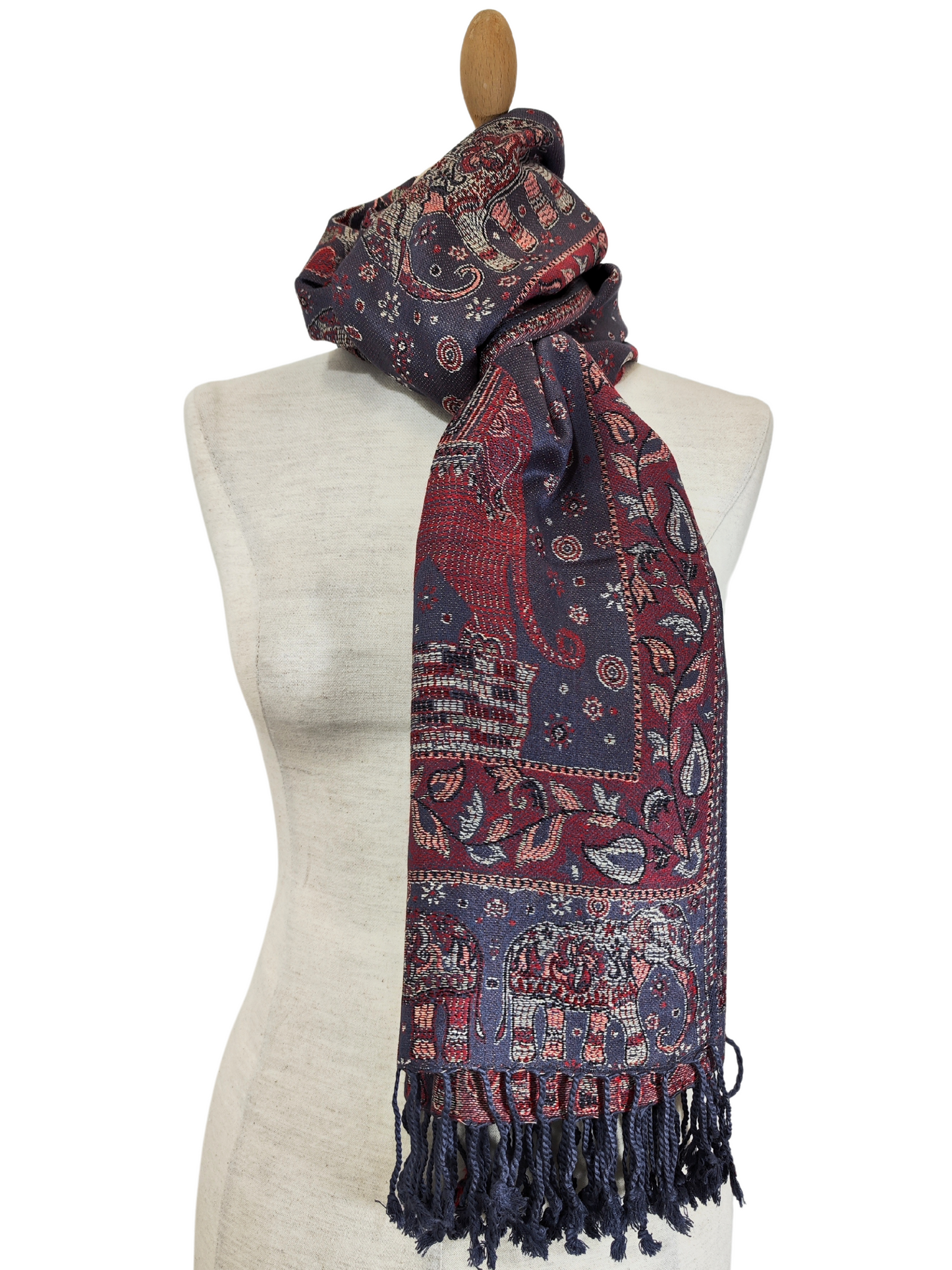 Beautiful pashmina shawl with a vibrant design. It has a predominantly purple background with intricate floral and elephant motifs in shades of red, gold, and blue
