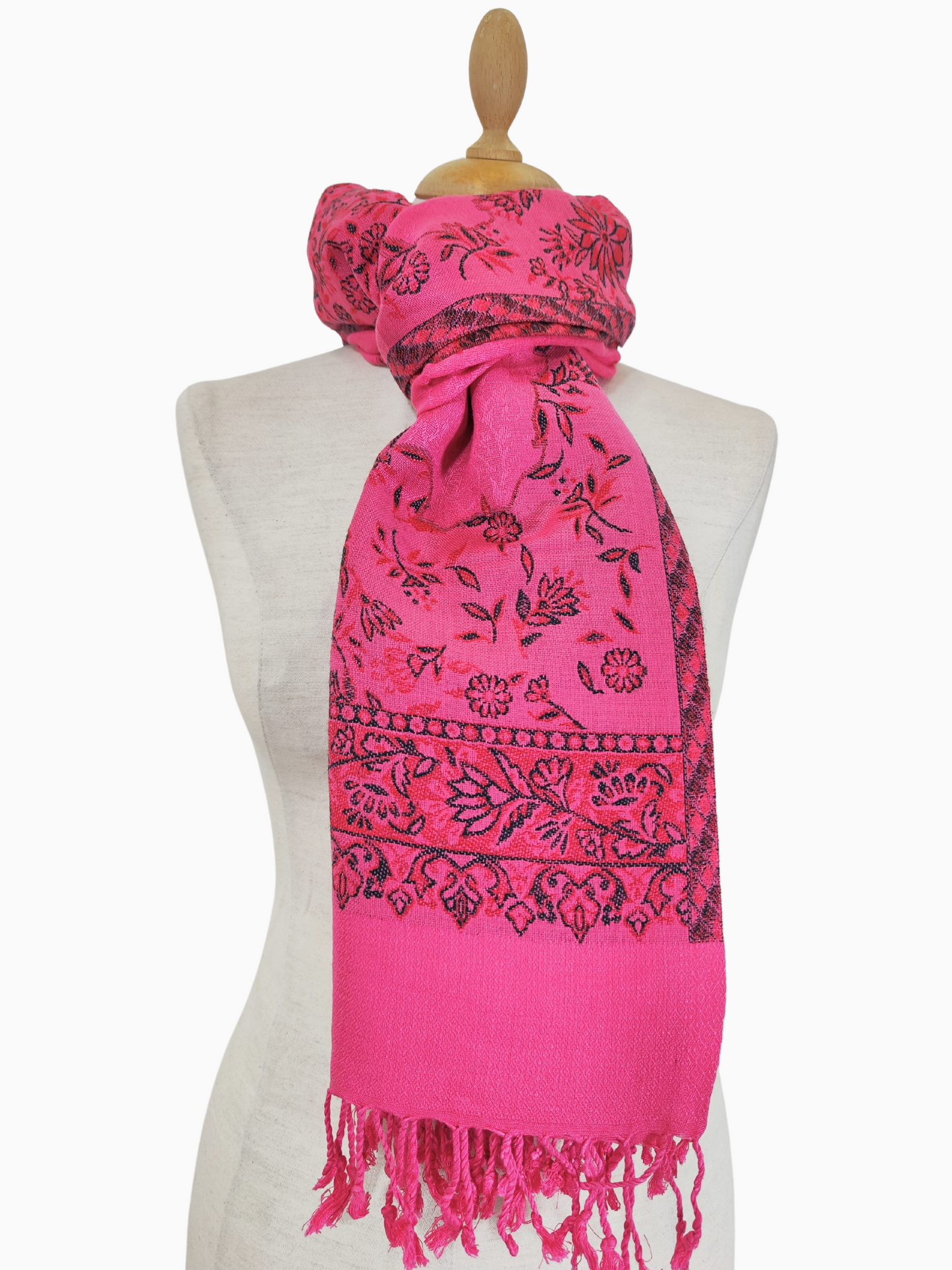 A vibrant pink pashmina shawl adorned with intricate black floral motifs