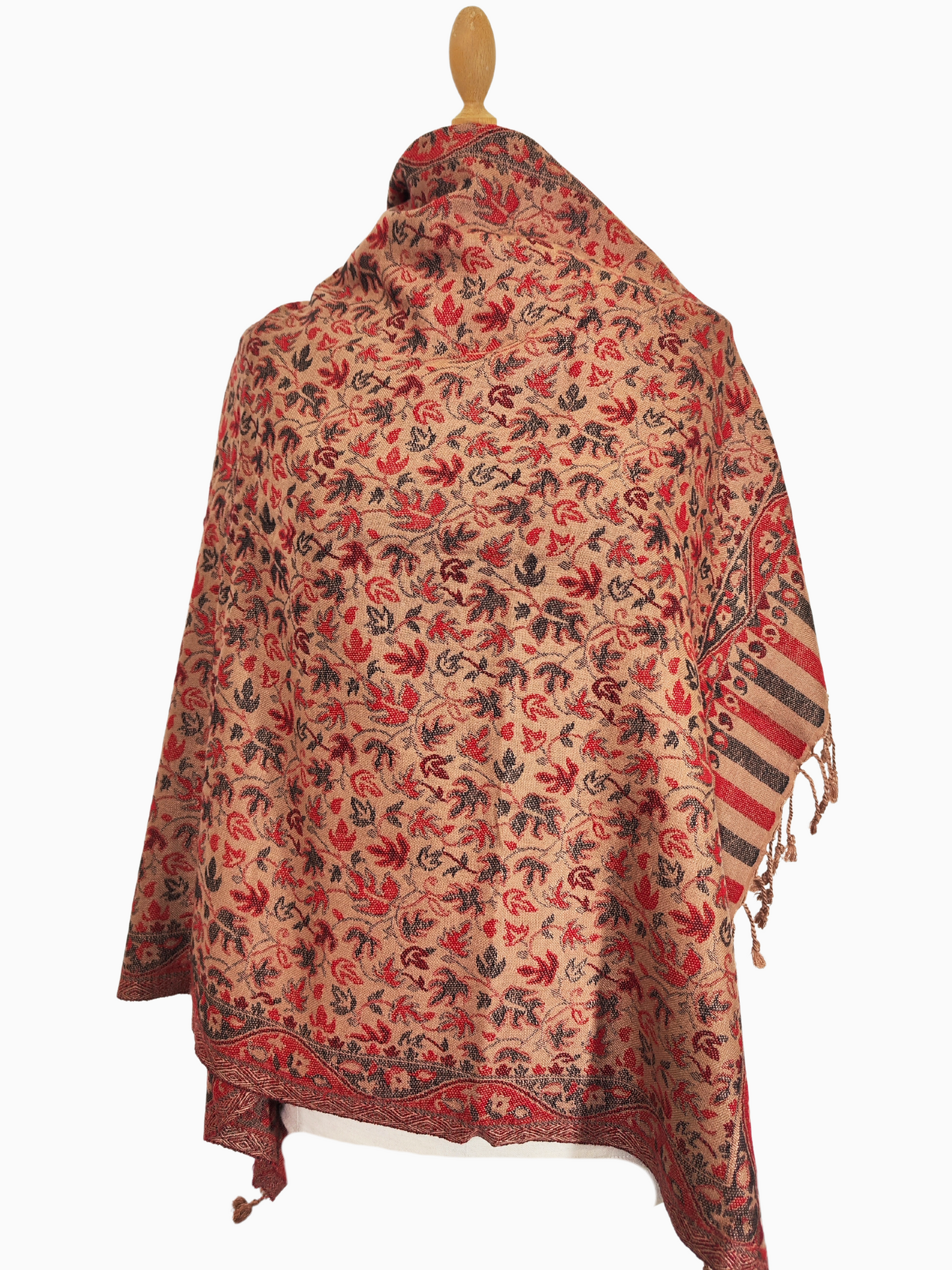 A pashmina shawl in warm red, brown, and cream tones with a floral and leaf pattern.
A luxurious pashmina shawl with intricate floral and leaf motifs, featuring a rich border and warm autumnal colours.
A soft, fine pashmina shawl in a warm colour palette, adorned with delicate floral and leaf patterns.
A whisper of autumn in a pashmina shawl, with warm colours and a delicate floral dance.