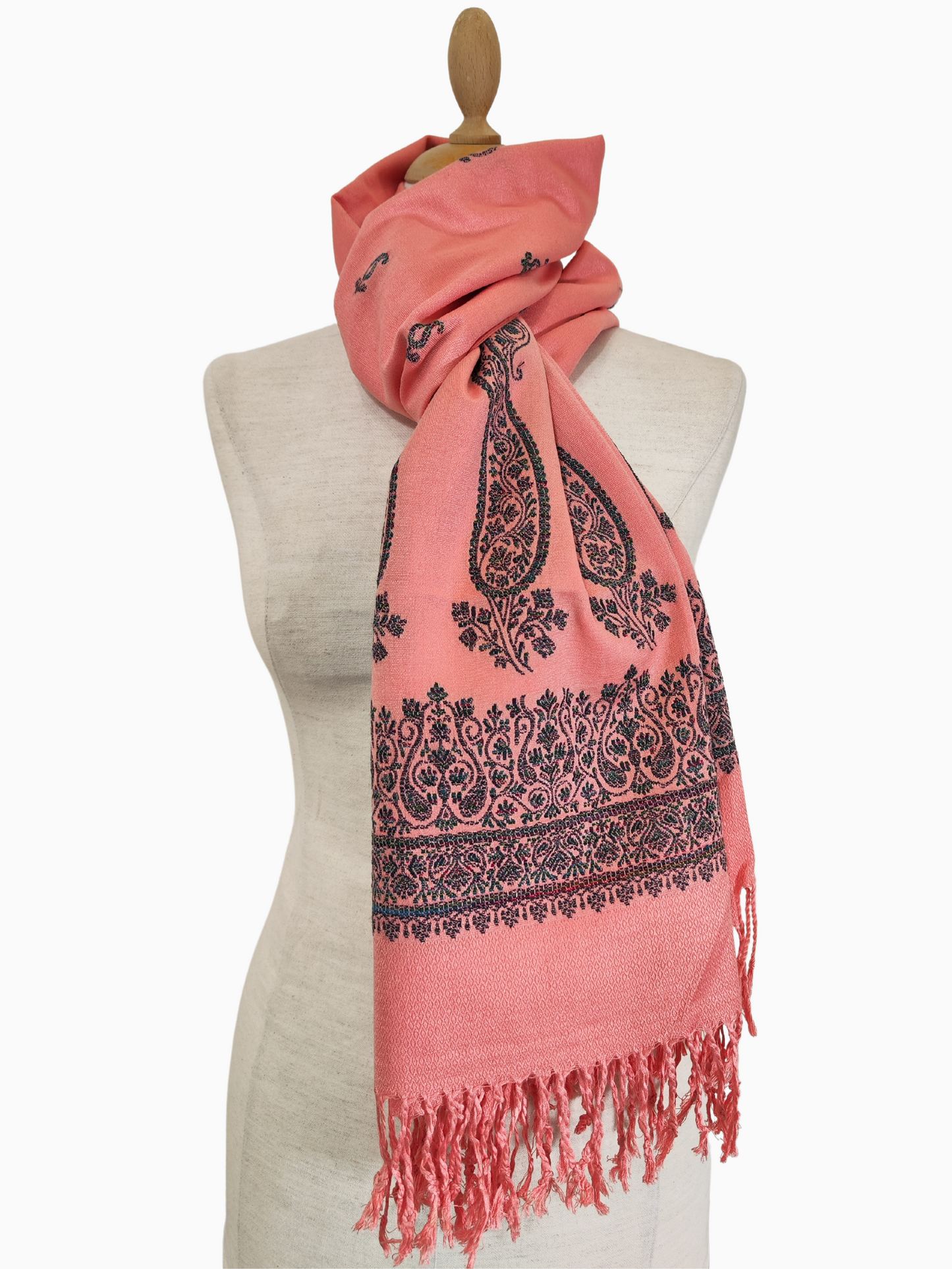 Elevate your wardrobe with this versatile peach-coloured cotton silk blend shawl. The classic black paisley pattern adds a touch of sophistication, making it perfect for both casual and formal occasions. Drape it over your shoulders, use it as a scarf, or tie it around your waist for a boho chic look.