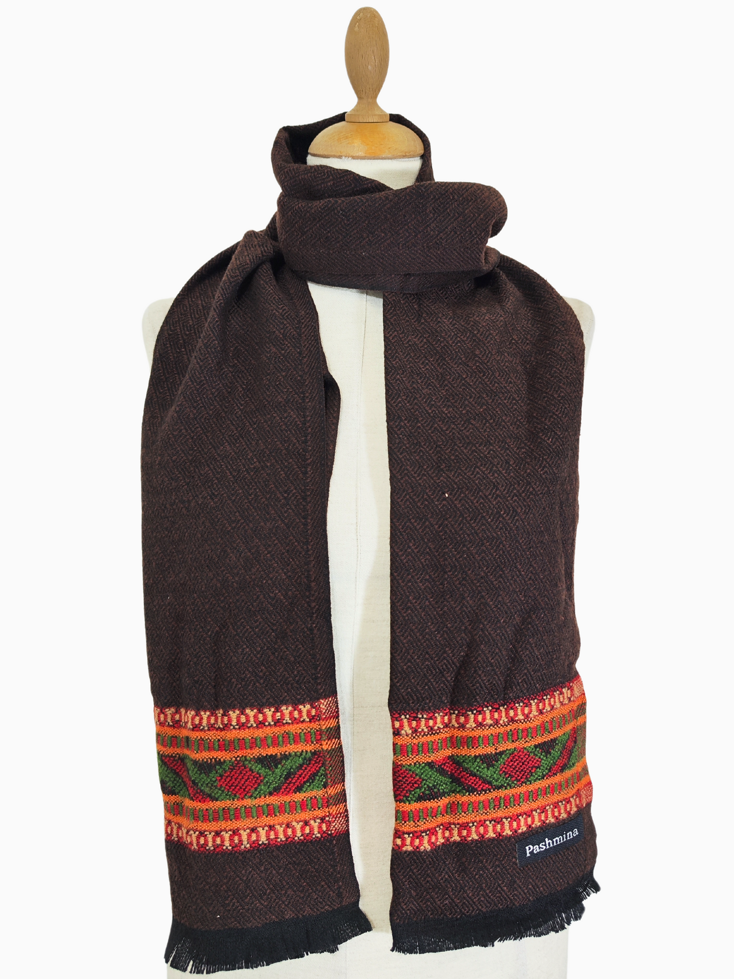 Dark brown woollen scarf with a vintage tribal pattern, designed for warmth and style during winter. This boho-chic accessory combines cosy comfort with a timeless tribal aesthetic, perfect for cold weather and casual layering.