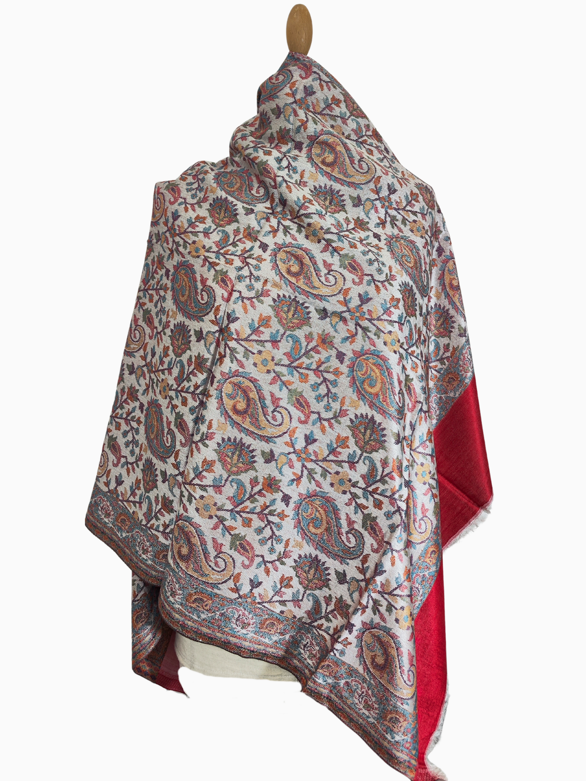 Stay warm and stylish with this beautiful Pashmina shawl. Featuring a captivating floral pattern in red, blue, and green. Buy now. Intricate paisley motifs and vibrant floral patterns adorn this elegant white Pashmina shawl. A touch of red adds a pop of color. Shop Pashmina shawls online