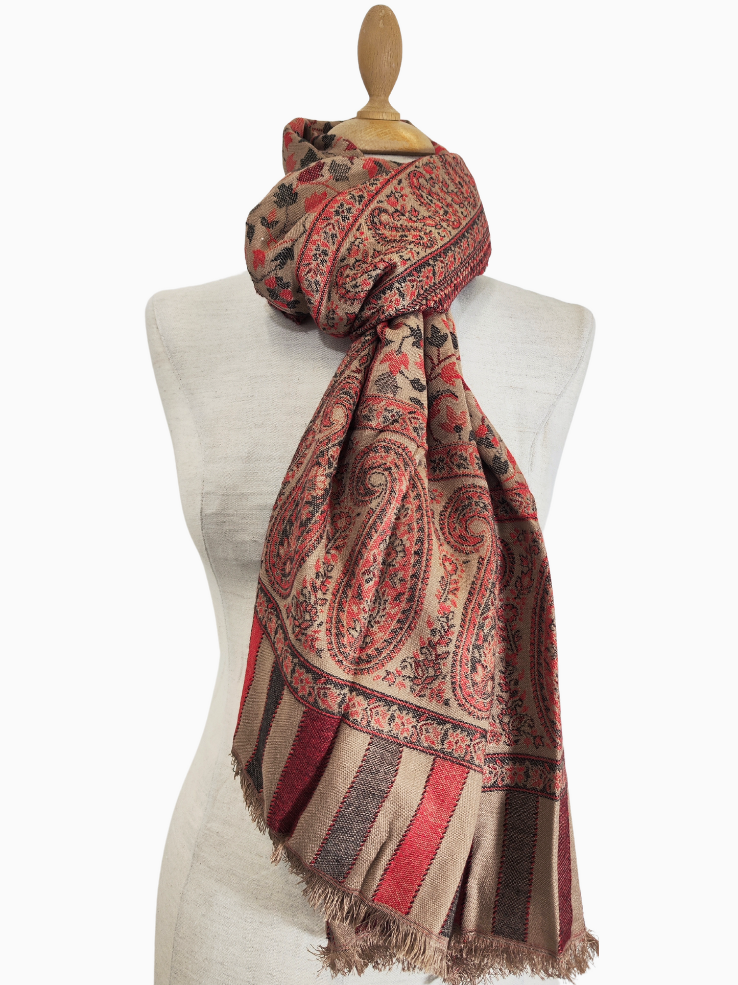 A Pashmina shawl with intricate floral and paisley patterns in shades of brown, red, and cream.
A luxurious Pashmina shawl draped over a mannequin, showcasing its intricate floral and paisley motifs in warm tones of brown, red, and cream. The shawl features a delicate border with stripes and a subtle floral pattern.
A timeless piece of art, this Pashmina shawl exudes elegance with its intricate floral and paisley patterns and rich, earthy colours.